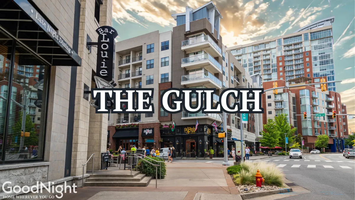 A lively exterior scene showing Bar Louie and modern apartment buildings in The Gulch, with pedestrians and traffic signals creating an energetic urban atmosphere. The image captures the area's renowned dining and social scene.