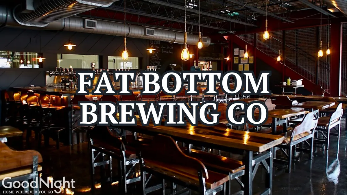 An inviting interior of a local craft beer bar or eatery, featuring long wooden tables, industrial lighting, and a bustling bar area. The lively setting suggests a sociable atmosphere perfect for trying local brews and cuisine.