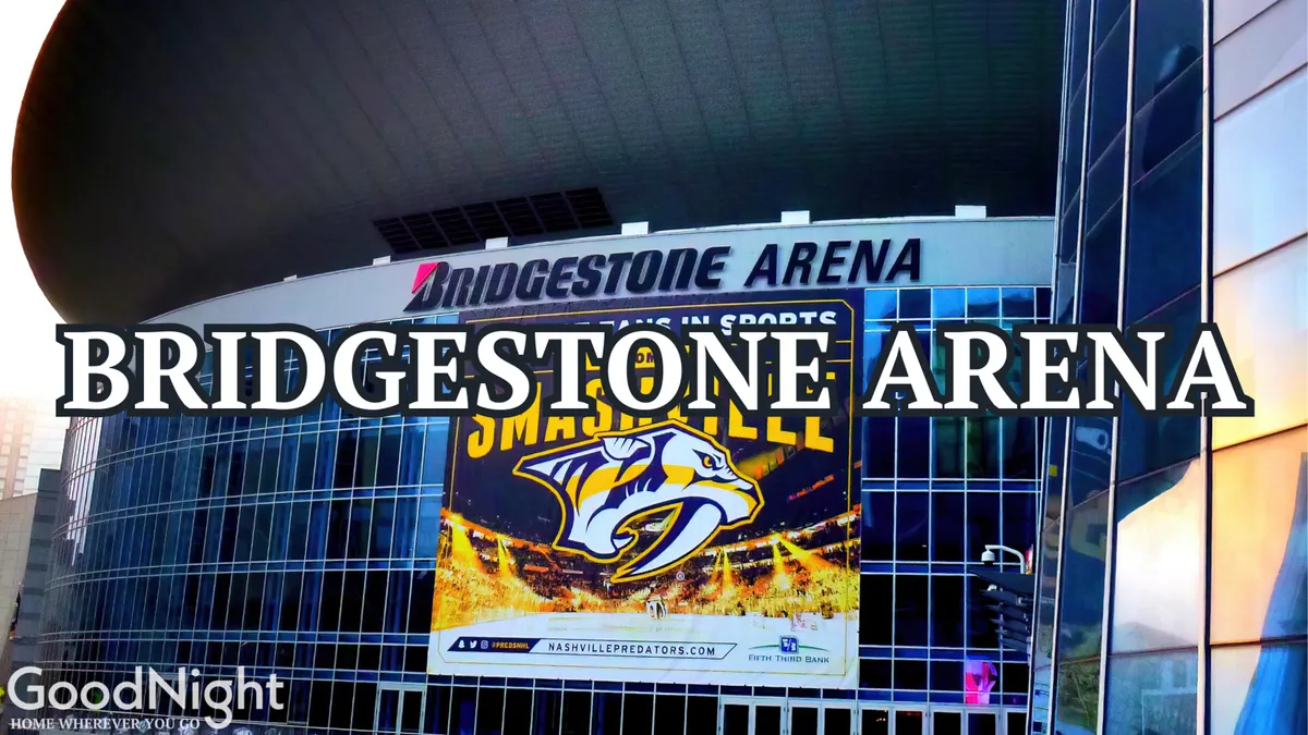 The modern exterior of Bridgestone Arena, featuring its bold signage and banners. The scene hints at big events, concerts, and sports excitement, all in the heart of downtown. A bustling atmosphere surrounds the venue, highlighting its role as a hub of activity.